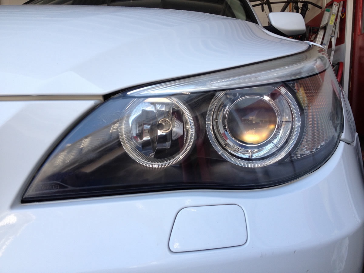 Fully restored BMW headlight — crystal clear projector and reflector after ceramic coating
